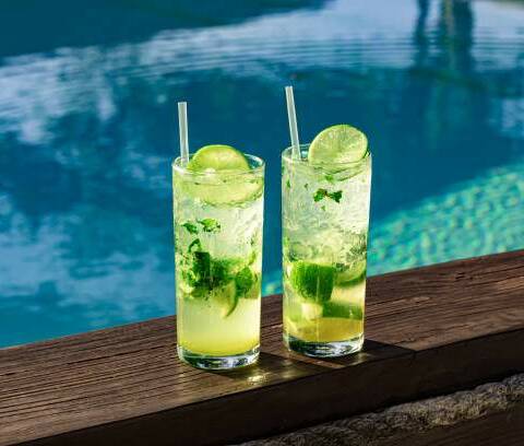 two fresh and cool mojitos with ice cubes