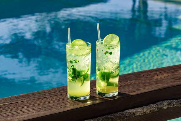 two fresh and cool mojitos with ice cubes