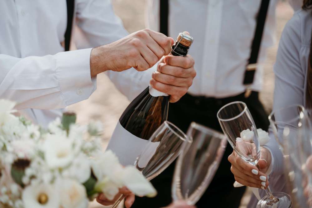 Professional bartenders mixing and serving drinks at a wedding celebration.