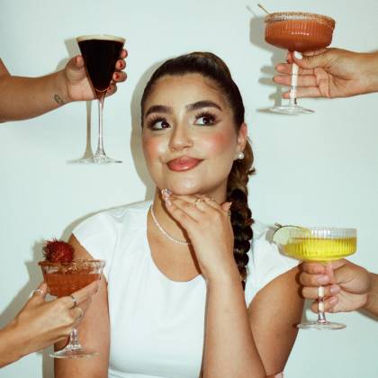 aliyah surrounded by hands holding various cocktails